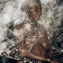 A monochrome cultural fragment of a Himba woman, representing the 'Ancestral Echoes' archive and the enduring heritage of the Kunene.