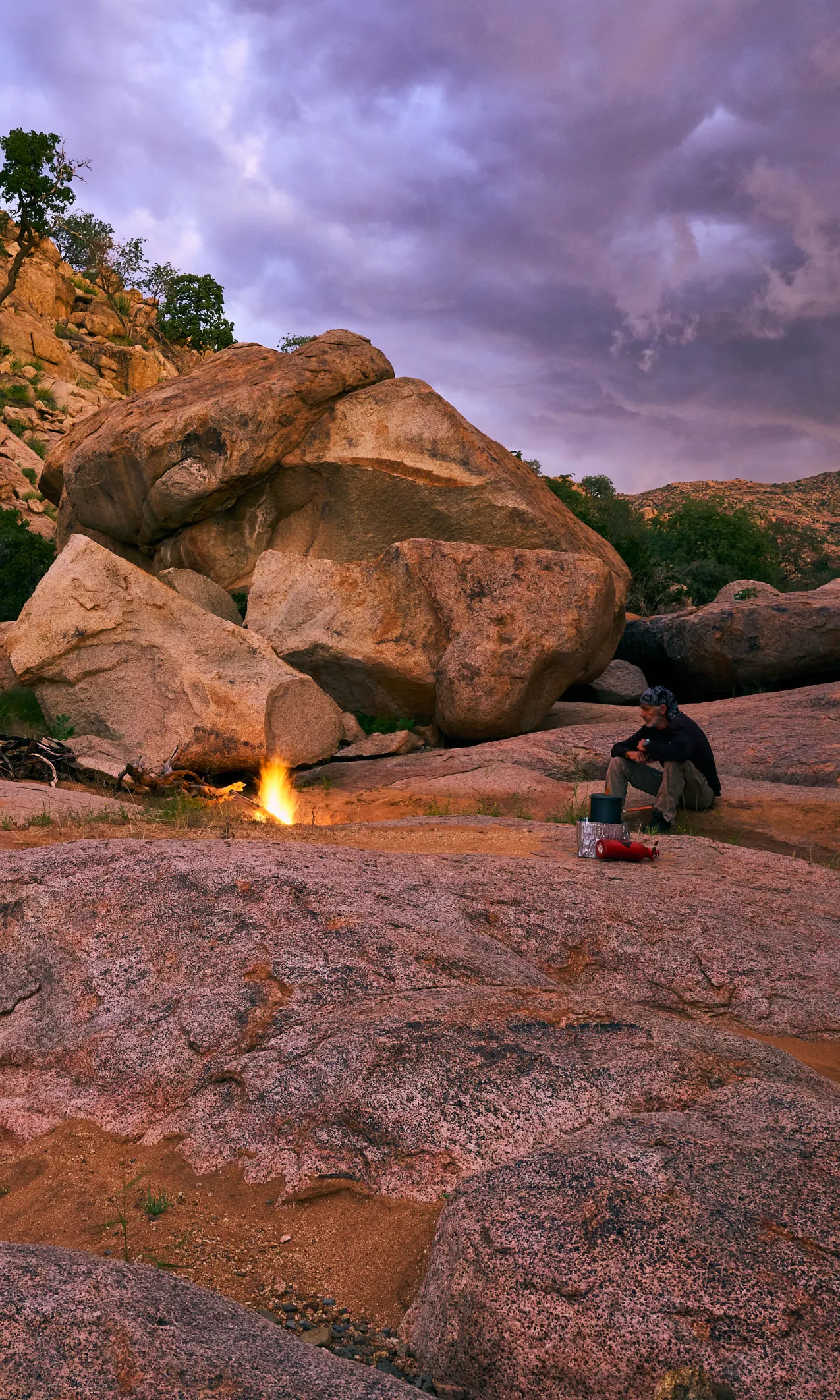 A panoramic view from a secluded high-altitude sanctuary amidst the granite peaks, where the jagged horizon meets the expansive sky in the last light of day.