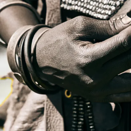 An abstract fine-art study of a Himba hand, documenting the rhythmic textures and ochre-stained 'geography' of a life anchored to the ancestral rhythms of the Kunene.
