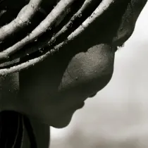 A monochrome portrait study of a Himba woman, capturing the ancestral dignity and human narrative of the remote Kunene region.