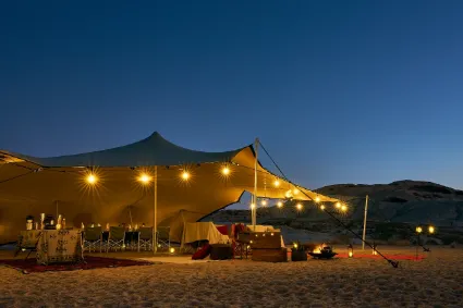 The central living space of the mobile camp, designed as an open-air architectural bridge between guests and the wilderness.