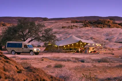 An expansive view of the Divine Namibia camp footprint, illustrating the dignity of a low-impact, high-luxury presence in the wild.