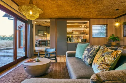 Interior architecture of a guest suite, where minimalist design meets the raw, unyielding beauty of the surrounding wilderness.