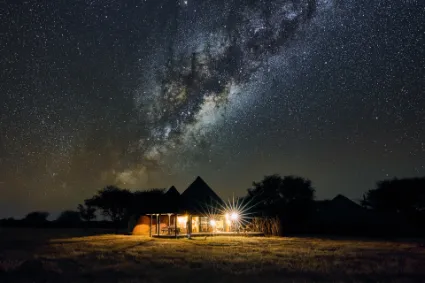 A monumental long-exposure study of the Milky Way arching over the secluded African Villa, documenting the unyielding clarity of Namibia's dark-sky frontiers.