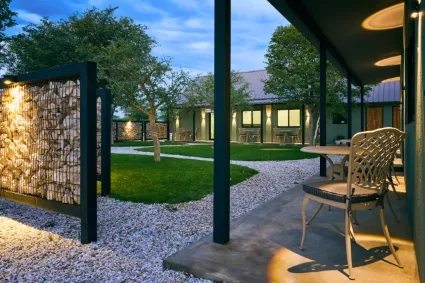 The central lodge architecture, serving as the social heart of the property with an open-plan design that invites the outside in.