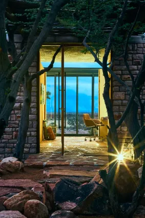 The architectural entrance to a private villa, highlighting the use of natural stone and the sense of exclusivity inherent to the property.