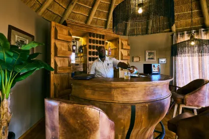 The intimate cigar lounge at Namib Outpost, documenting a space of quiet reflection and old-world elegance in a modern wilderness setting.