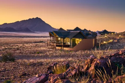A wide-angle perspective of the suite's isolated position, highlighting the privacy and skeletal beauty of the lodge's desert footprint.