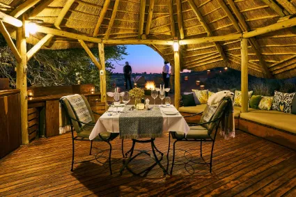 A secondary perspective of the luxury camp's culinary heart, highlighting the seamless transition between the interior design and the red Kalahari dunes.