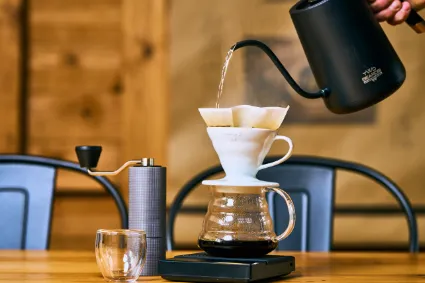 A professional culinary study of a freshly prepared coffee, showcasing the intricate latte art and the refined quality of the Two Beards sensory experience.