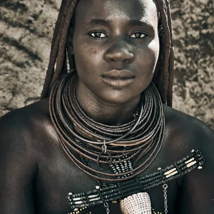 A detailed study of a Himba woman's traditional attire and 'Erembe' headpiece, documenting the symbolic language of their customary dress.