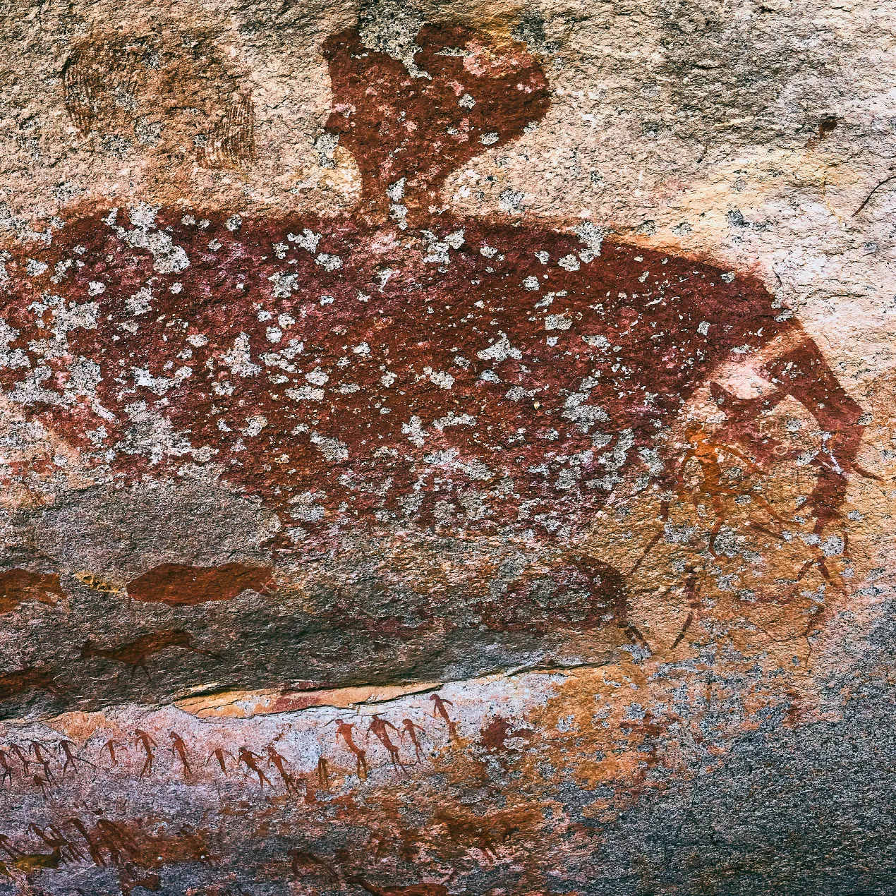 A monumental 12,000-year-old rock painting of 'The Giant' in the Brandberg; a towering double-headed figure mirroring the negative space of the summer Milky Way and ancient global archetypes.