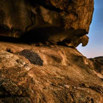 A minimalist silhouette of the 'Eagle's Nest' rock formation; a symbolic fragment of the silent frontier and a gateway to the Dying Realms.