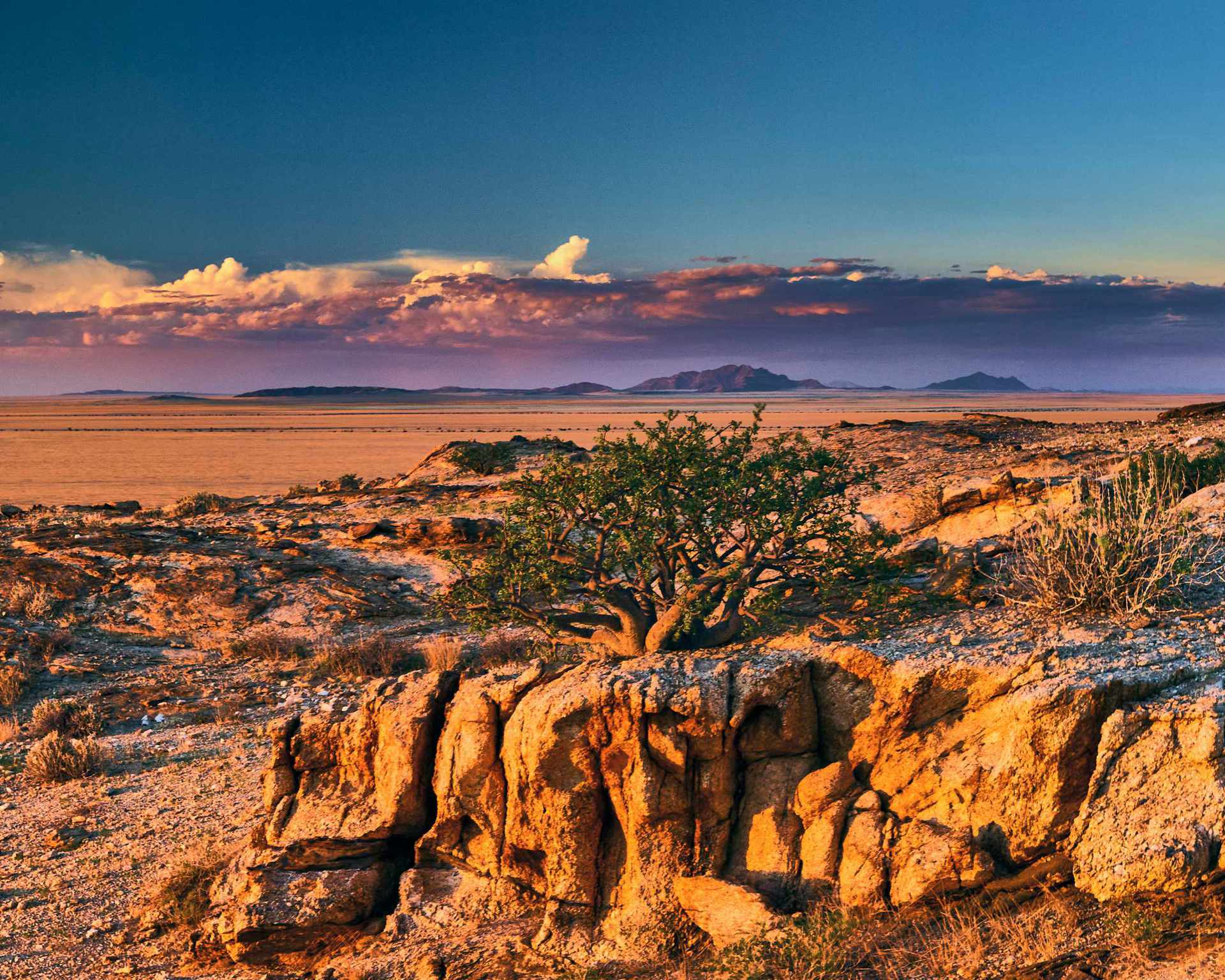 Photograph of clouds covering the plains of the Namib, taken from Mirabib in the Naukluft Park, showcasing the vast and dramatic landscape under a dramatic sky.